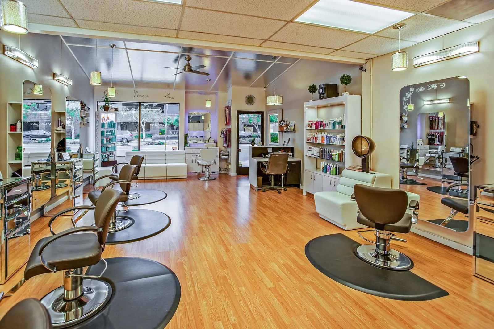 A bright hair salon with styling chairs